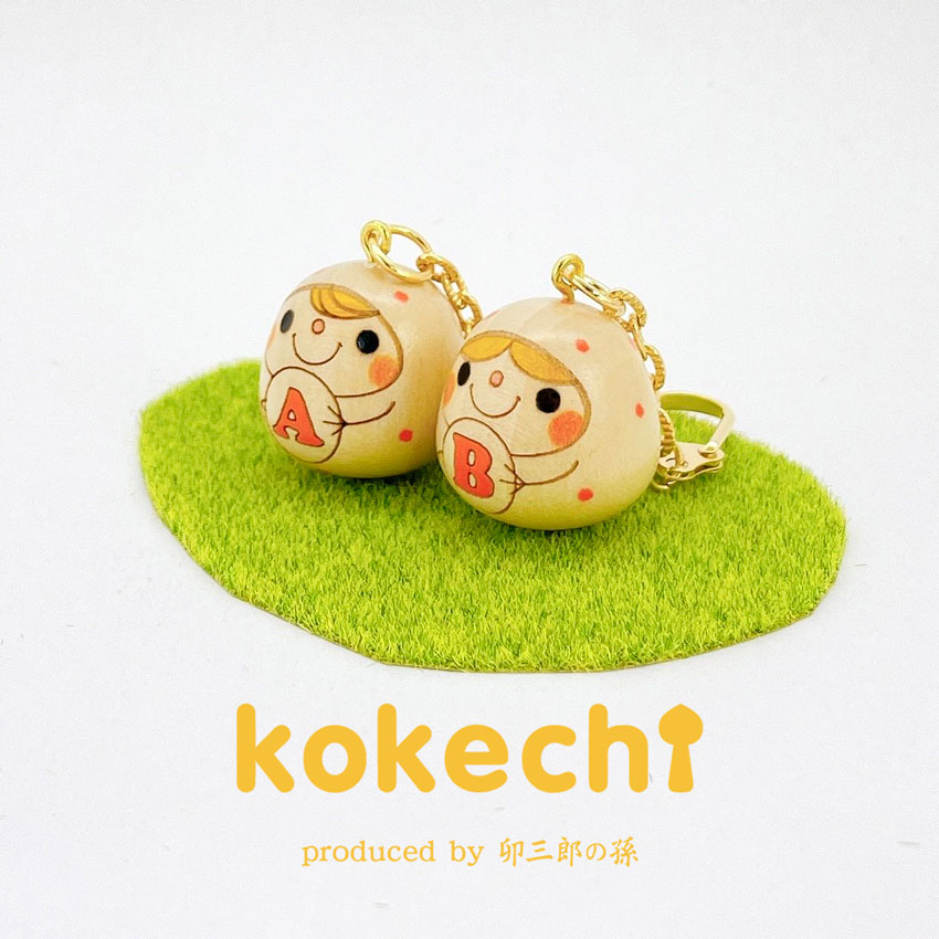 伝統的な木製こけし オレンジと黒のデザイン