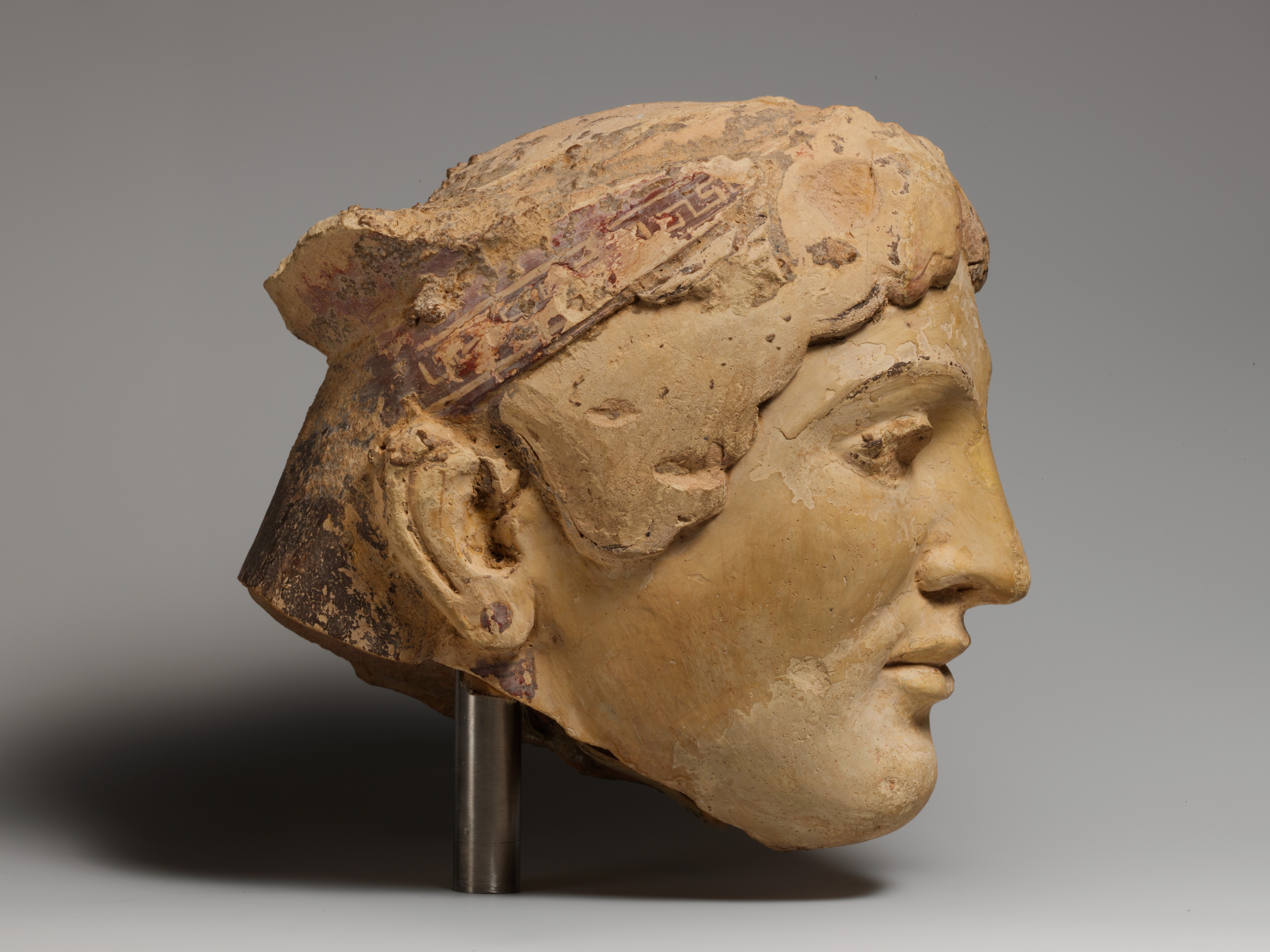 Terracotta head of a woman, probably a sphinx - Greek - Archaic
