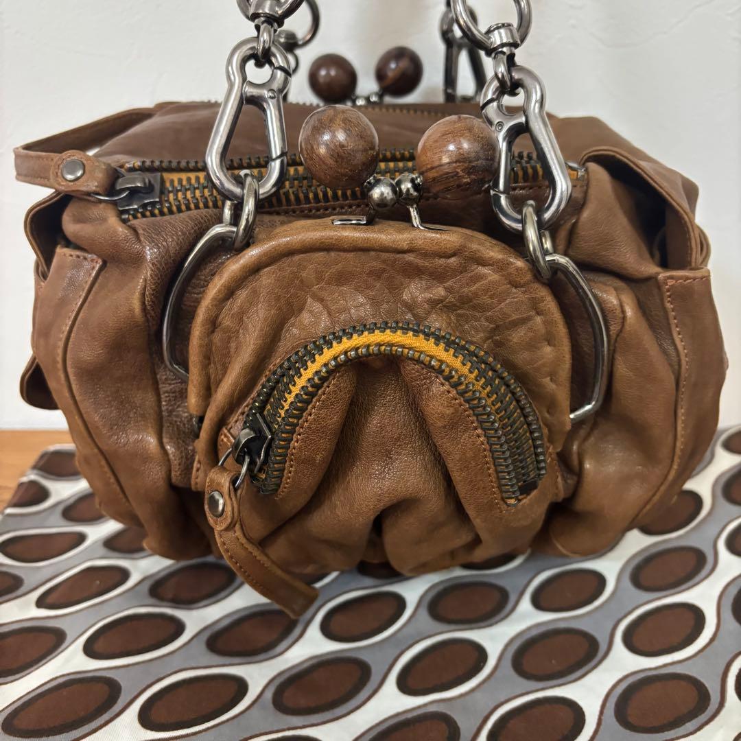 ジャマンピュエッシュ　レザー　ハンドバッグ　木製パーツ　がま口　総柄